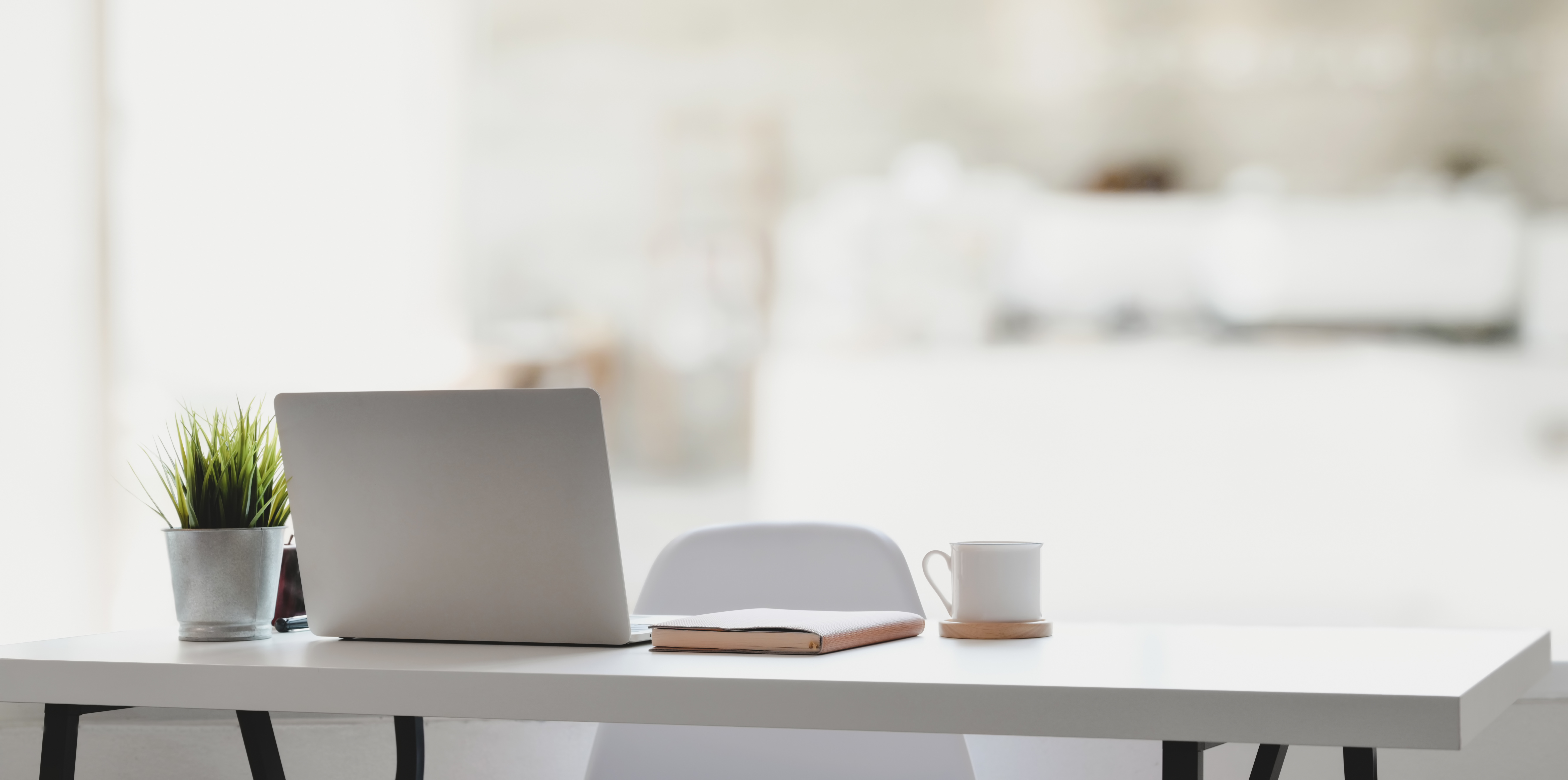 Comfortable workplace with laptop computer, coffee cup and office supplies